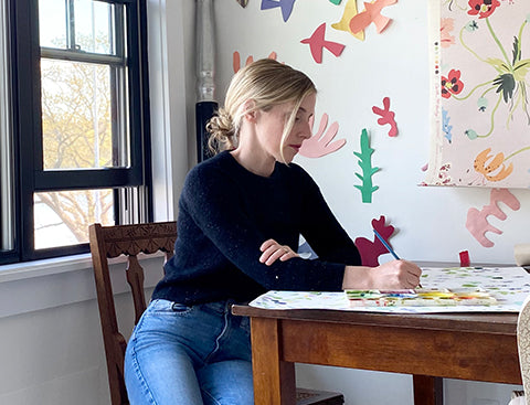 caitlin painting at the table