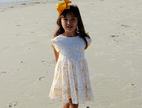 Kelsey wears her Niley Dress in Starfish print on the beach. Click to read the full Q&A with Kelsey and her mom!
