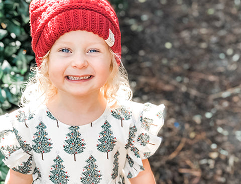 Roey from South Carolina smiles in her Holiday Kit dress. Click to read all about Roey.